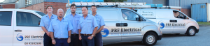 prf electrical team photo standing in front of vehicles