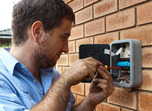 man fixing switch board