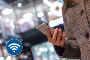 man holding iphone showing wifi