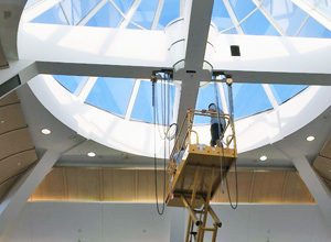 man on excavator installing lights